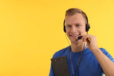 Technical support call center. Smiling operator with clipboard on yellow ba.. Stock Photos