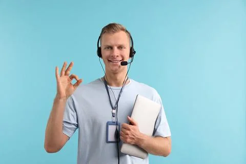 Technical support call center. Smiling operator with laptop showing ok gest.. Stock Photos