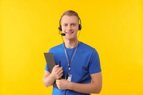Technical support call center. Smiling operator with clipboard on yellow ba.. Stock Photos