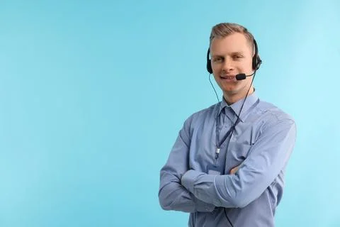 Technical support call center. Smiling operator with crossed arms on light .. Stock Photos