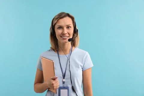 Technical support call center. Smiling operator with tablet on light blue b.. Stock Photos