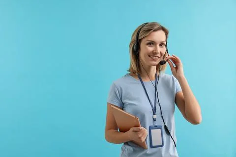 Technical support call center. Smiling operator with tablet on light blue b.. Stock Photos