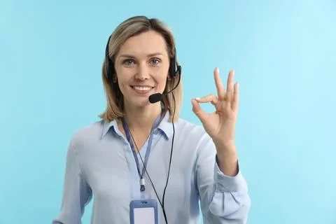 Technical support call center. Smiling operator showing ok gesture on light.. Stock Photos
