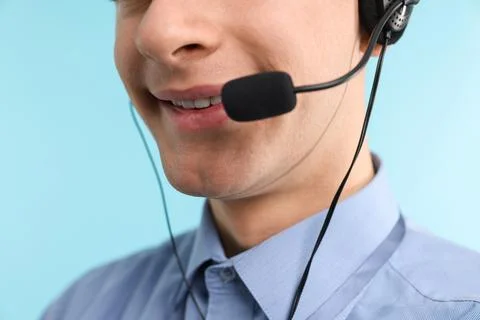 Technical support call center. Smiling operator on light blue background Stock Photos