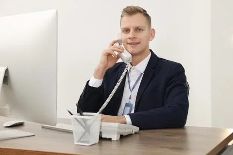 Technical support call center. Smiling operator working at table in office Stock Photos