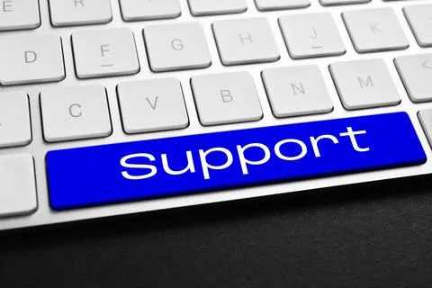 Technical support. Computer keyboard with word on blue button, closeup 库存照片