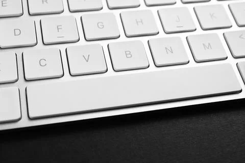 Technical support concept. Modern keyboard on black background, closeup 写真素材
