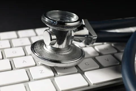 Technical support concept. Stethoscope and keyboard on black background, cl.. Stock-Fotos