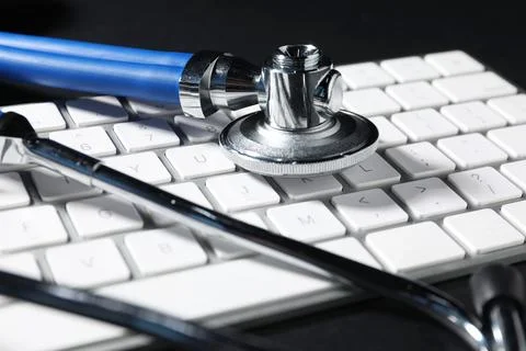 Technical support concept. Stethoscope and keyboard on black background, cl.. Stock-Fotos