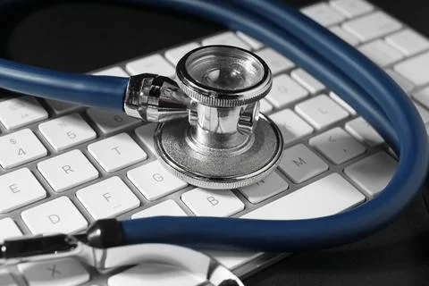 Technical support concept. Stethoscope and keyboard on black background, cl.. Stock-Fotos