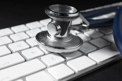 Technical support concept. Stethoscope and keyboard on black background, cl.. Stock-Fotos