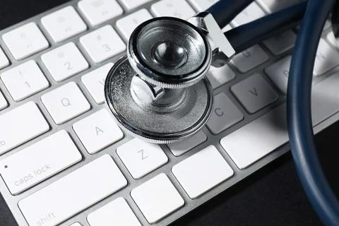 Technical support concept. Stethoscope and keyboard on black background, cl.. Stock-Fotos