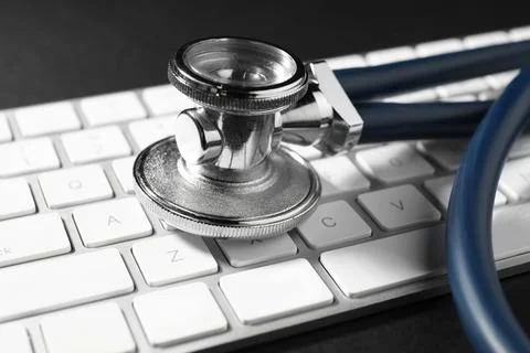 Technical support concept. Stethoscope and keyboard on black background, cl.. 写真素材