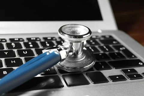 Technical support concept. Stethoscope on laptop keyboard, closeup Stock-Fotos
