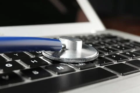 Technical support concept. Stethoscope on laptop keyboard, closeup Stock-Fotos