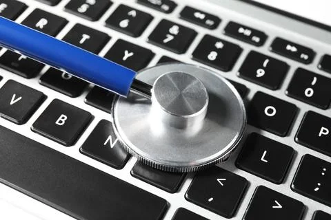Technical support concept. Stethoscope on laptop keyboard, closeup Stock-Fotos