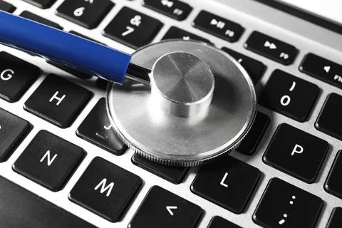 Technical support concept. Stethoscope on laptop keyboard, closeup Stock-Fotos