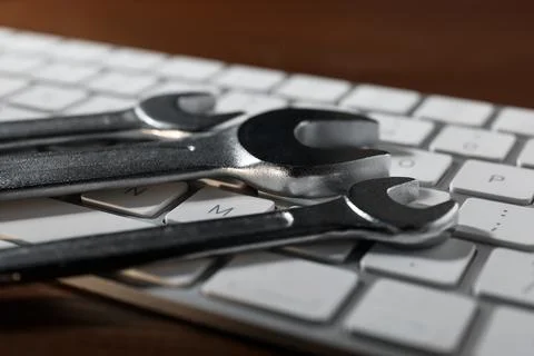 Technical support concept. Wrenches and keyboard on wooden background, closeu 写真素材