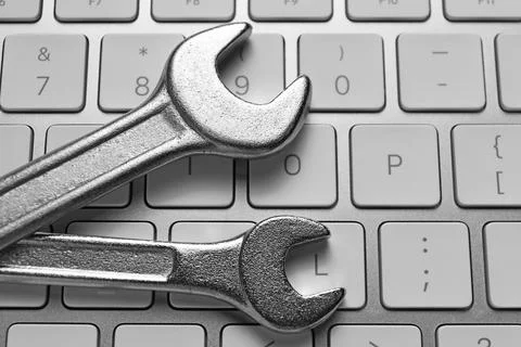 Technical support concept. Wrenches on keyboard, top view Stock-Fotos