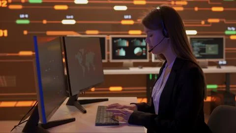 Technical support in control room. Female IT specialists in headsets work on Stock Photos