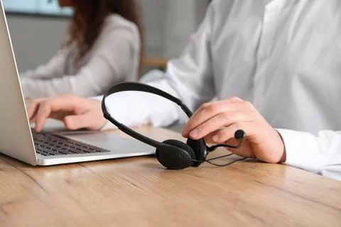 Technical support operator with headset at workplace, closeup Stock Photos