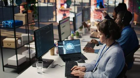 Technical support specialist in call center office using AI chatbot Stock Photos