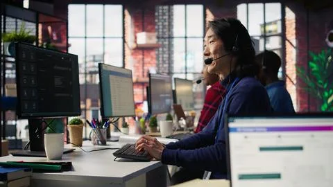 Technical support specialist in call center office doing troubleshooting Stock Photos