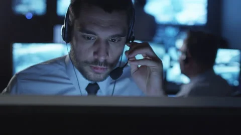 Technical support specialist is talking on a headset while working on computer 스톡 동영상 59610673