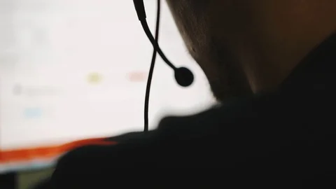 Technical support specialist is talking on a headset while working Video stock 101685580