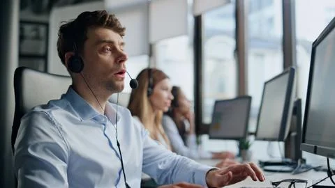 Technical support talk client in office. Pensive man specialist typing computer Stock Photos