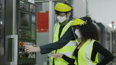 Technical team wears face mask to work laptop to check machinery in industrial Stock Footage 157640420