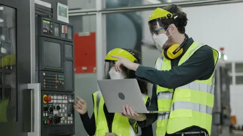 Technical team wears face mask to work laptop to check machinery in industrial Stock Footage 157640587