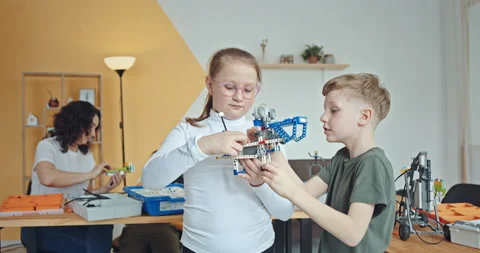 Technical training for children: children in the robotics classroom work on Stock Footage 171780041