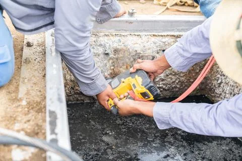 Technicial use drilling cordless drill pit wall. Stock Photos