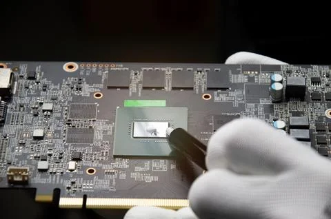 The technician is adding cooling silicone. Graphics motherboards and graphi.. Stock Photos