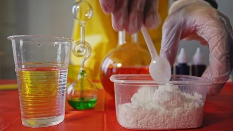 Technician adds reagents into the flask Stock Footage 103383834