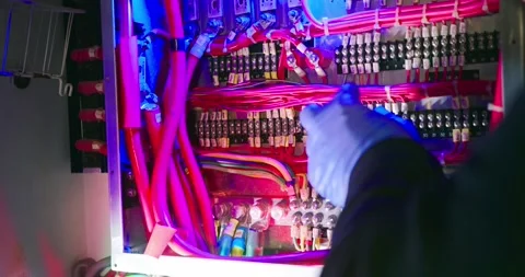 Technician Adjusting Electrical Components in Engine Room Stock Footage 323746844