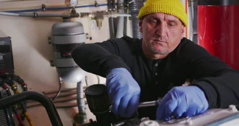 Technician Adjusting Equipment in Engine Room Stock Footage 323738237