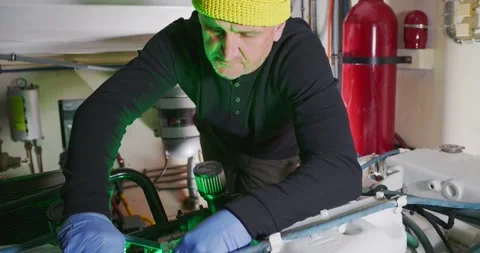 Technician Adjusting Equipment in Engine Room Stock Footage 323738738