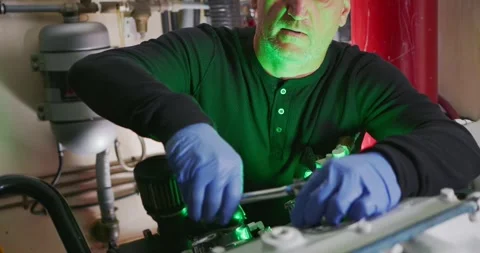 Technician Adjusting Machinery in Engine Room Stock Footage 323736084