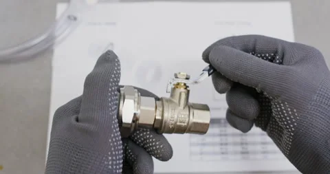 Technician adjusts handle stop screw and verifies lever travel 動画素材 322008810