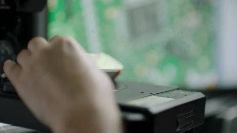 Technician Adjusts Microscope to Inspect Circuit Board Components in Laboratory Stock Footage 334053579