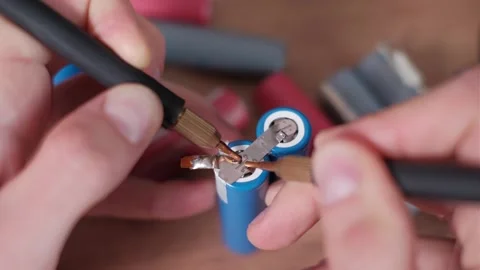 Technician Aligns Spot Welder for Lithium Battery Assembly Stock Footage 306214496