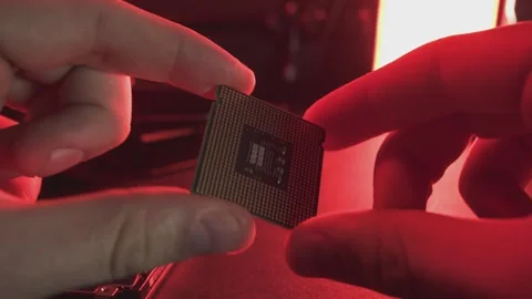 Technician analyzing a cpu microchip under dramatic red lighting Stock Footage 296761934