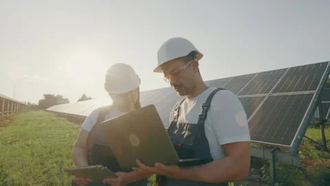A technician and engineer inspect and check the operation of solar panels Stock Footage 261155481