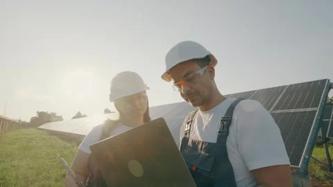 A technician and engineer inspect and check the operation of solar panels Stock Footage 263753641