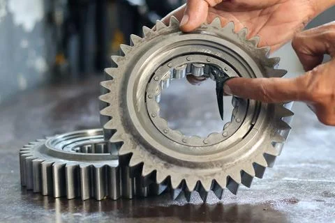 Technician Applying Grease to Gear with Roller Bearing. Stock Photos