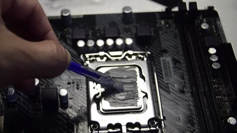 Technician is applying thermal silicone to CPU. Stock Footage 303233411