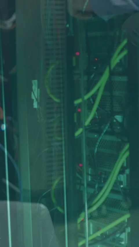 Technician approaching workstation, arm reaching into rack, adjusting cables and Stock Footage 332806547