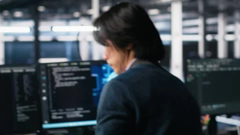 Technician arriving in data center office, coding with generative AI Stock Footage 313566580